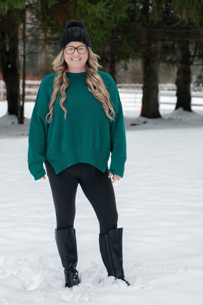 Amanda in a green sweater in the snow.