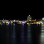 Downtown waterfront skyline at night with colorful building lights